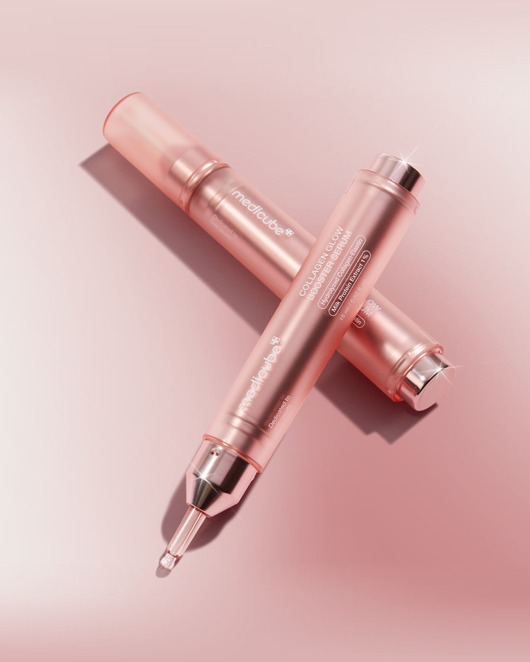 Medicube Collagen Glow Booster Serum 15ml: two pens crossed